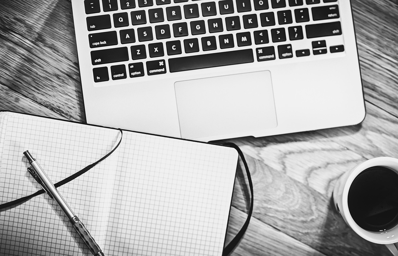 Computer, notebook, coffee — Benefits of Outsourcing Your PPC Needs to White Label Providers